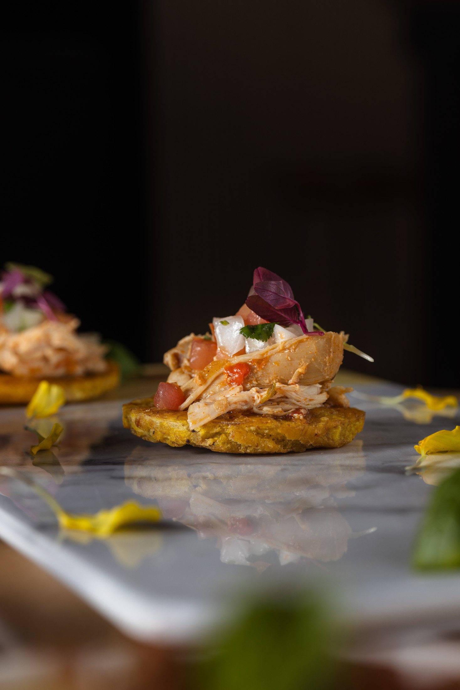 Sunset Bites — tostones topped with pulled chicken and pico de gallo