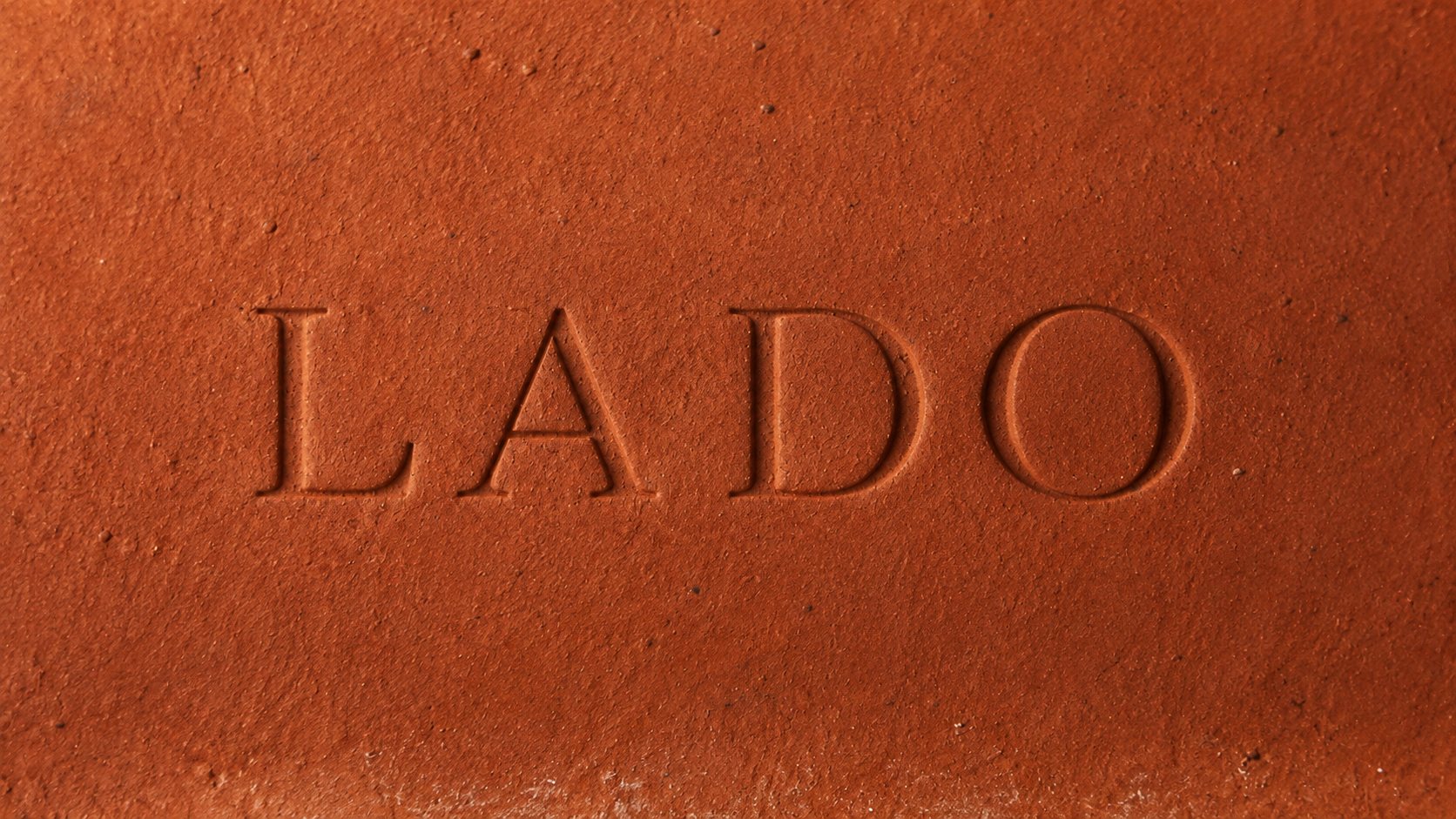 LADO wordmark engraved on terracotta brick